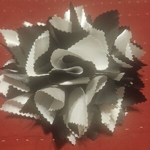 Women's black and white shoulder broch